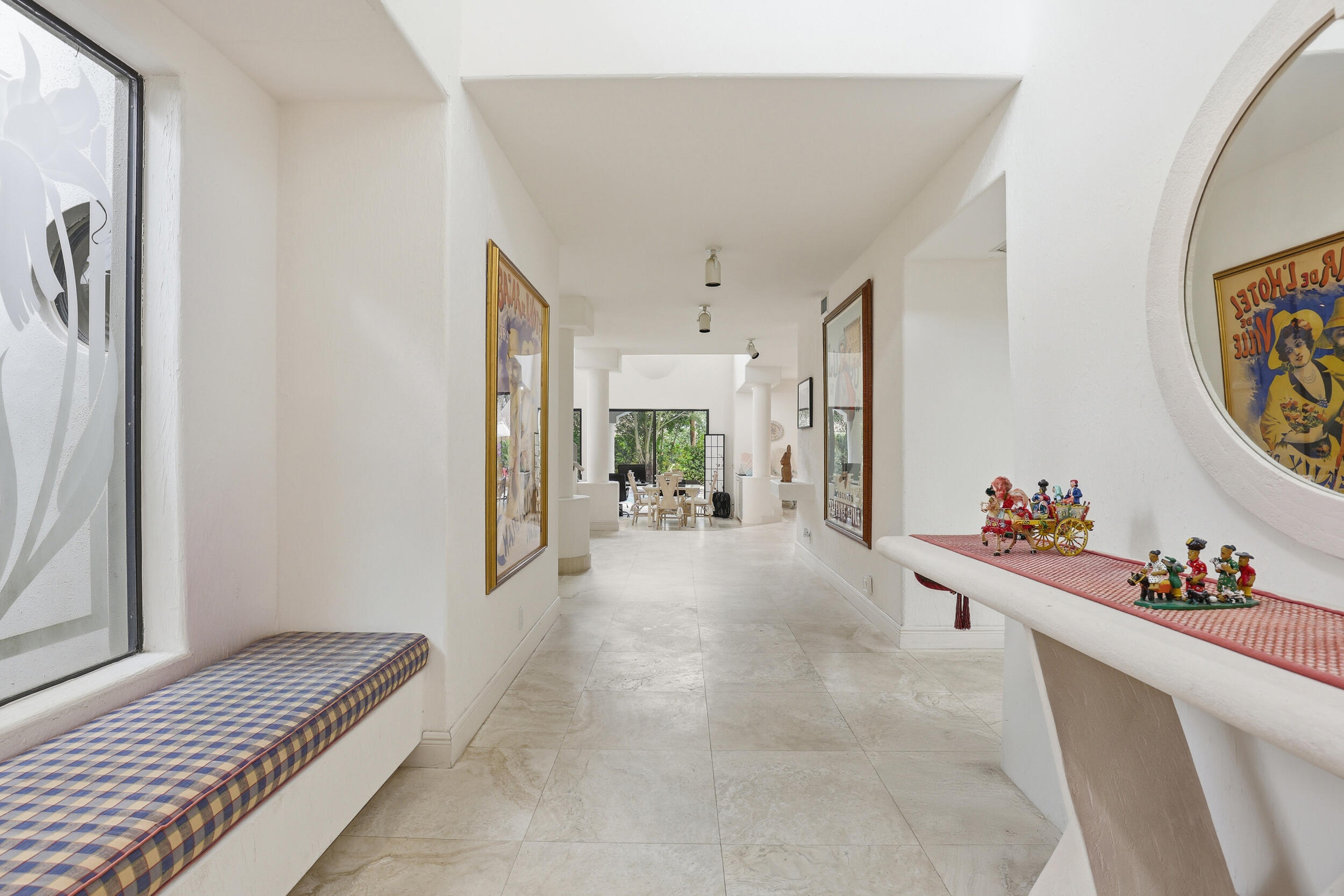 2248 Northwest 60th Street Boca Raton, FL 33496 - Photo 7 of 70 a view of a hallway to a livingroom with furniture and windows