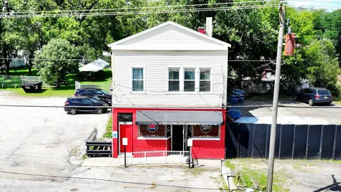 an aerial view of a house with outdoor space and street view