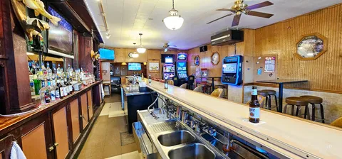 a view of empty room with wooden floor and windows