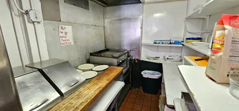 a kitchen with a refrigerator and a sink