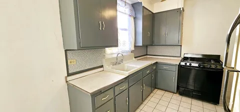a view of a patio with a table and chairs under an umbrella