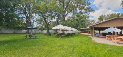 a view of a house with backyard and sitting area