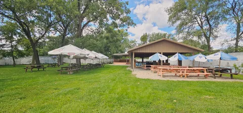 a view of a yard with a house in the background