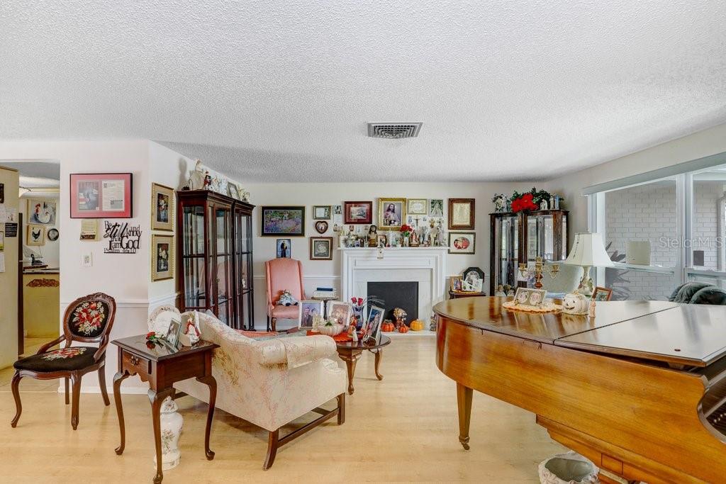 12600 Castleberry Court Bayonet Point, FL 34667 - Photo 21 of 52 a living room with furniture and a flat screen tv