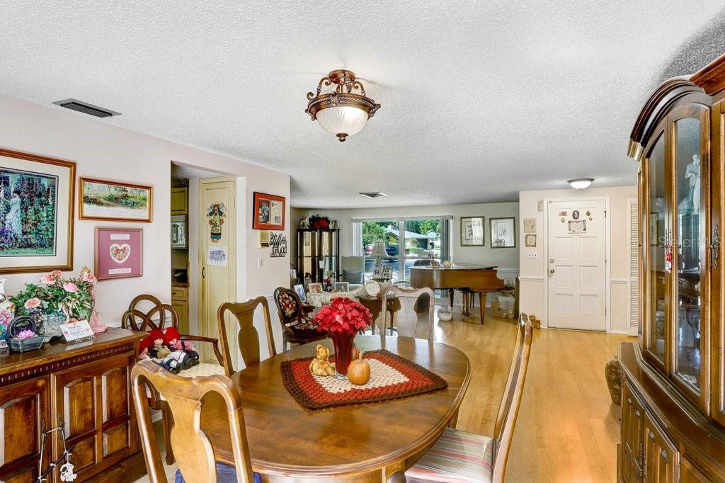 12600 Castleberry Court Bayonet Point, FL 34667 - Photo 24 of 52 a view of a dining room with furniture and a large window