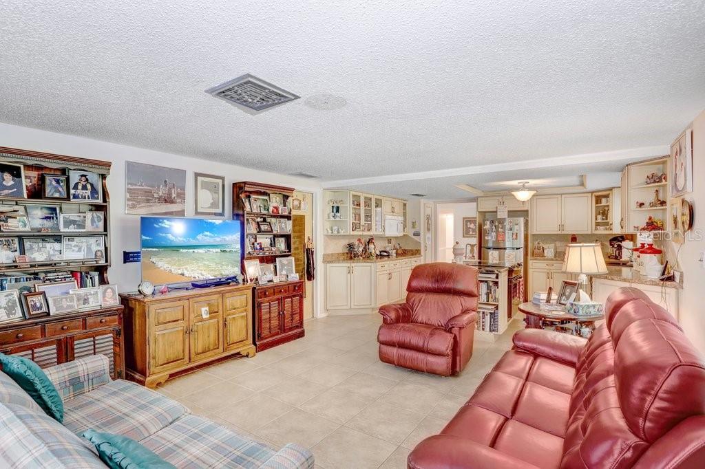 12600 Castleberry Court Bayonet Point, FL 34667 - Photo 26 of 52 a living room with furniture and book shelf