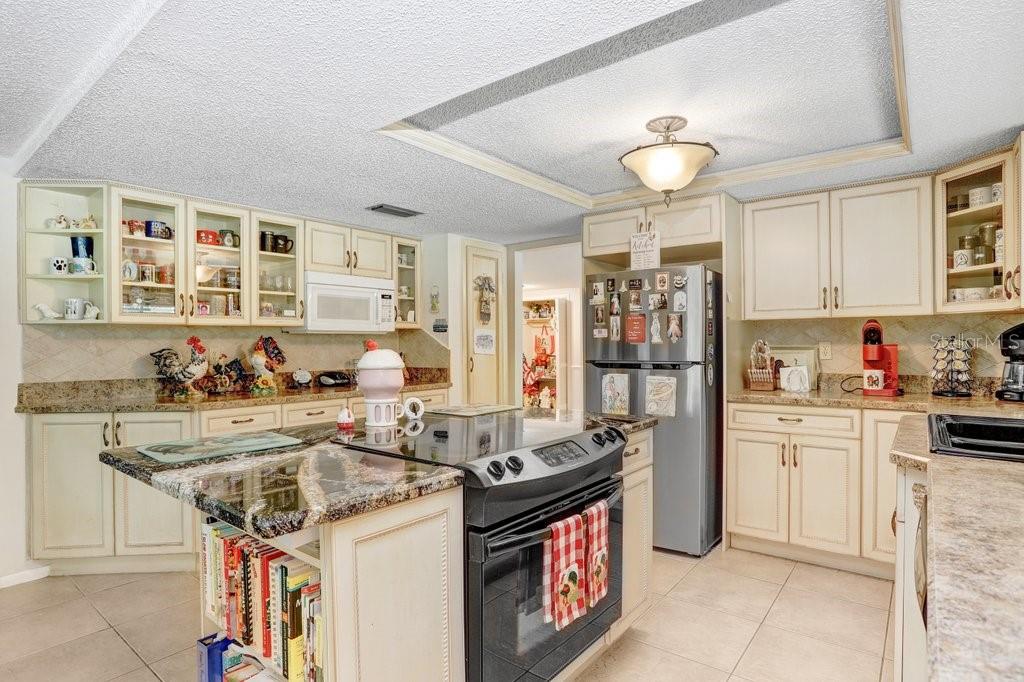 12600 Castleberry Court Bayonet Point, FL 34667 - Photo 29 of 52 a kitchen with stainless steel appliances granite countertop a stove and cabinets