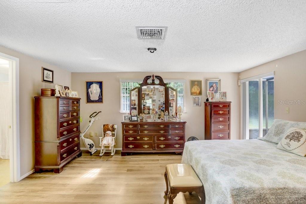 12600 Castleberry Court Bayonet Point, FL 34667 - Photo 31 of 52 a view of a bedroom with furniture and window