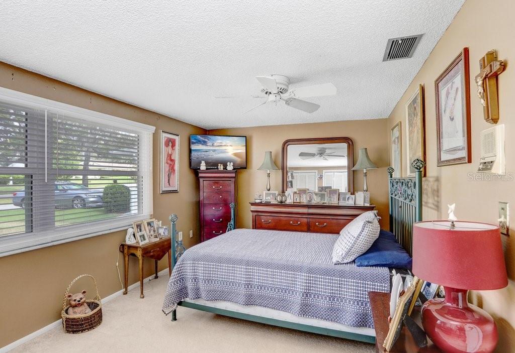 12600 Castleberry Court Bayonet Point, FL 34667 - Photo 34 of 52 a bedroom with a bed and wooden floor