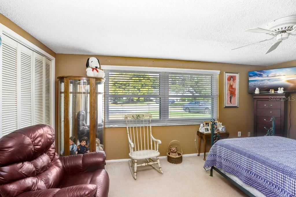 12600 Castleberry Court Bayonet Point, FL 34667 - Photo 35 of 52 a bedroom with a bed and wooden floor