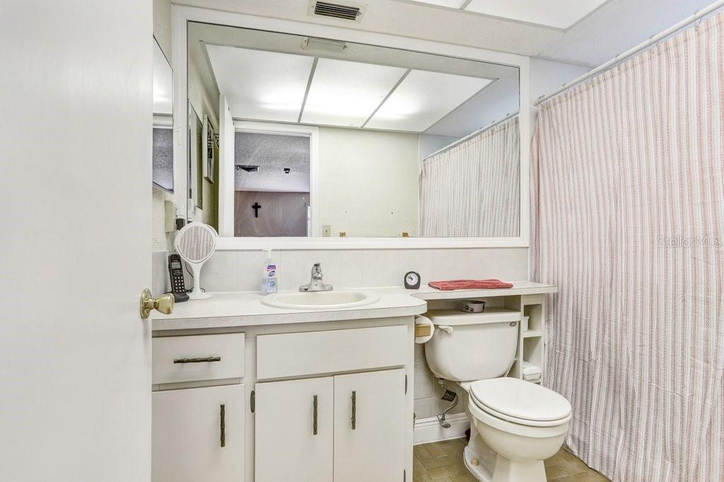 12600 Castleberry Court Bayonet Point, FL 34667 - Photo 37 of 52 a bathroom with a toilet sink vanity and mirror