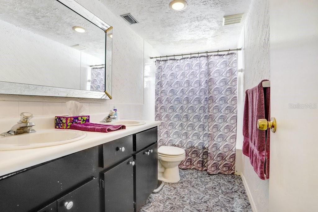 12600 Castleberry Court Bayonet Point, FL 34667 - Photo 38 of 52 a bathroom with a sink toilet and shower