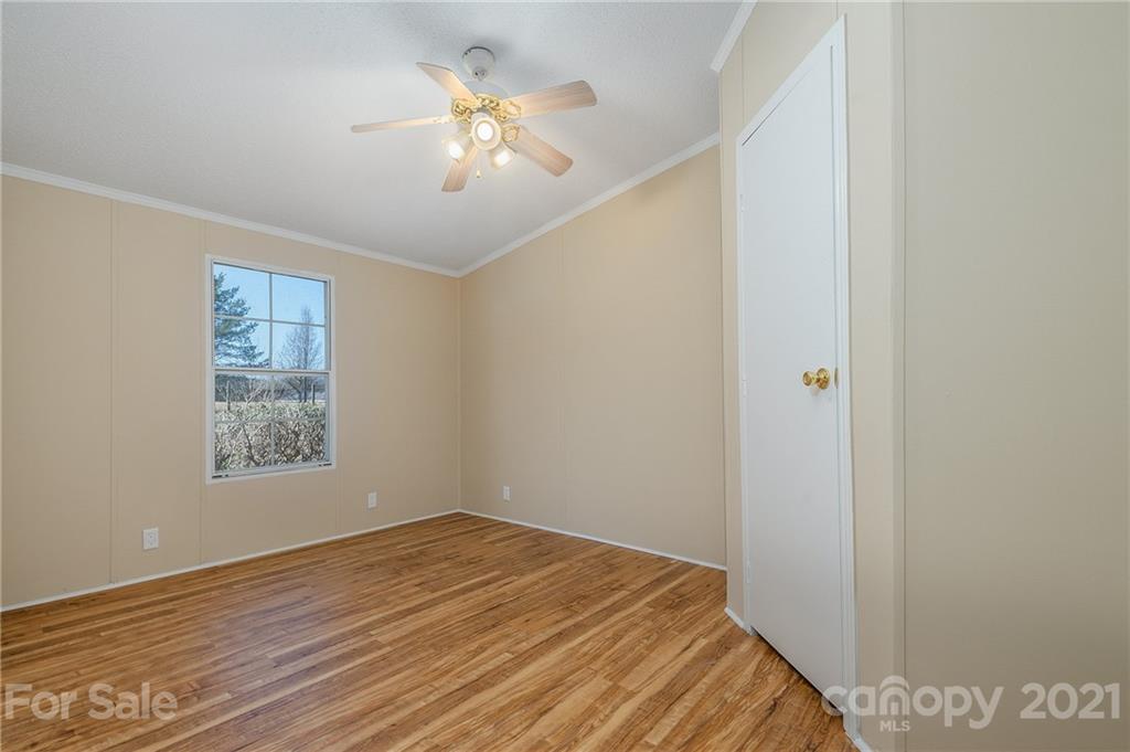 428 Elliott Rd Extension Rutherfordton, NC 28139 - Photo 22 of 41 a bedroom with a bed and a chandelier