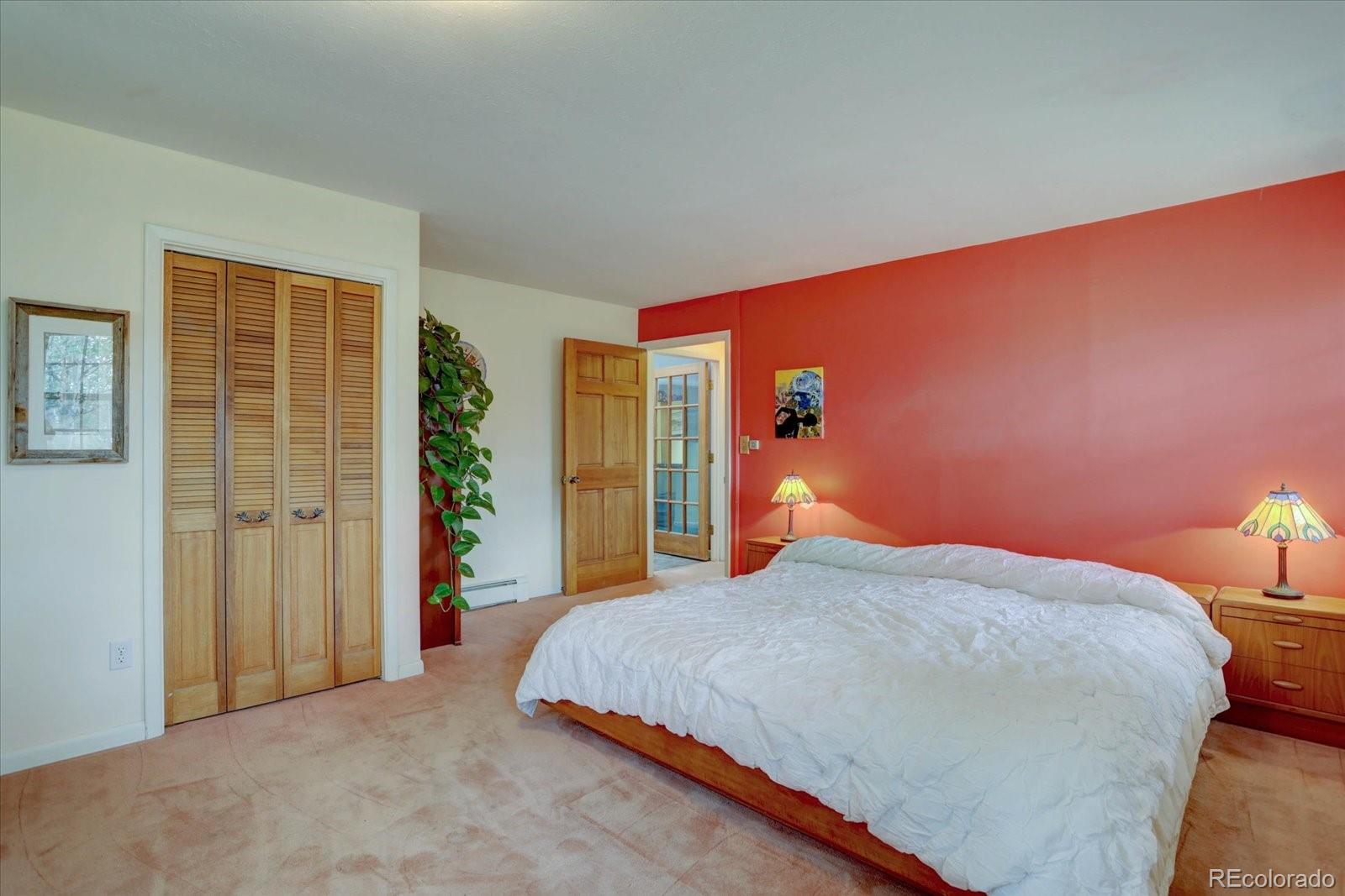 28858 Richmond Hill Road Conifer, CO 80433 - Photo 18 of 39 a bedroom with a bed and a lamp