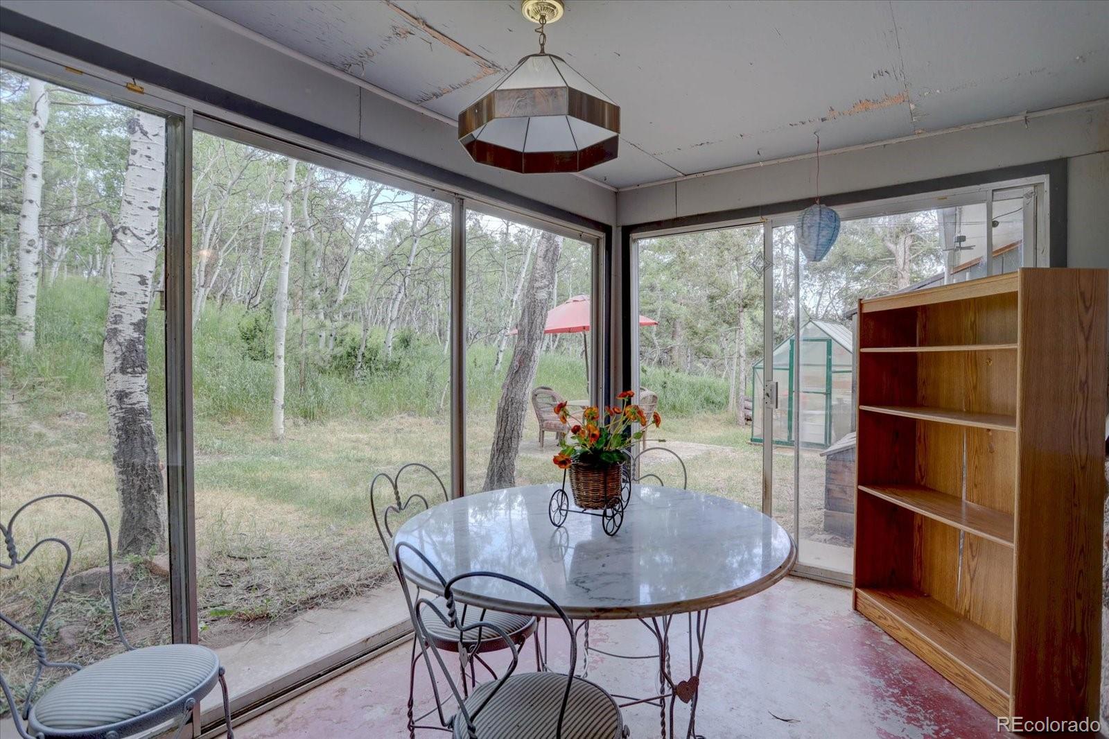 28858 Richmond Hill Road Conifer, CO 80433 - Photo 22 of 39 a view of a dining room with furniture window and outside view