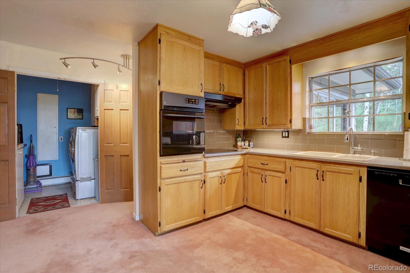 28858 Richmond Hill Road Conifer, CO 80433 - Photo 24 of 39 a kitchen with stainless steel appliances granite countertop a refrigerator and a sink