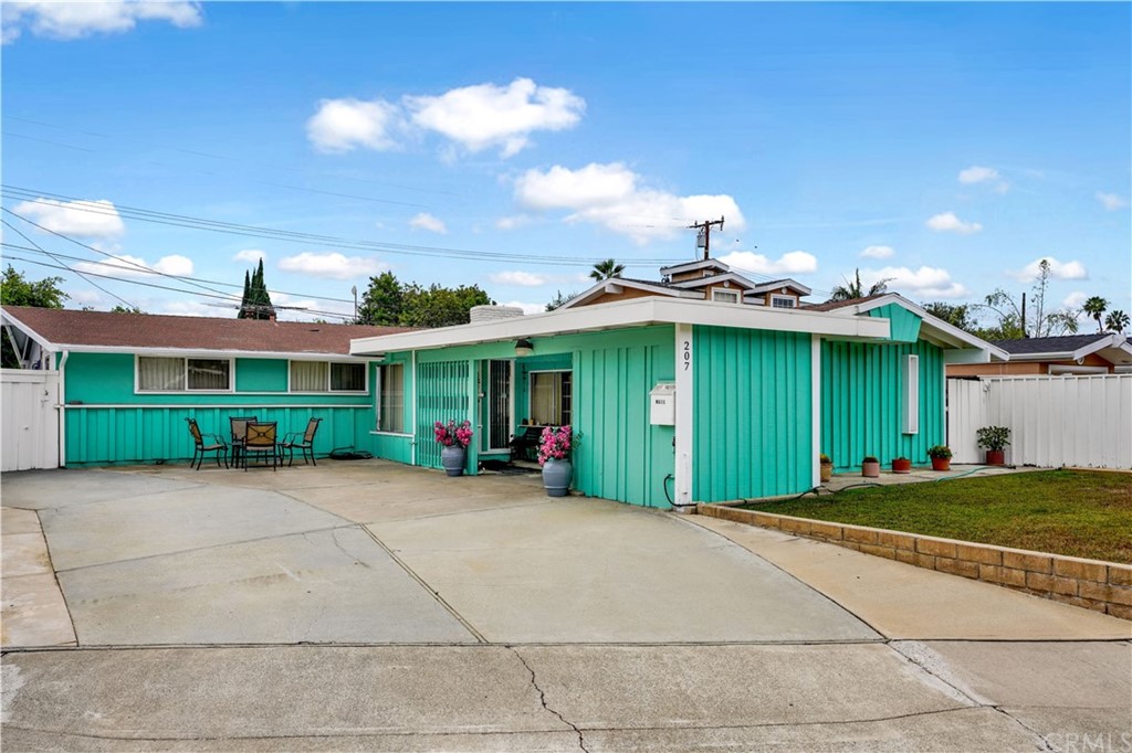 207 Hanover Drive Costa Mesa, CA 92626 - Photo 1 of 7 a view of a house with a patio and a yard