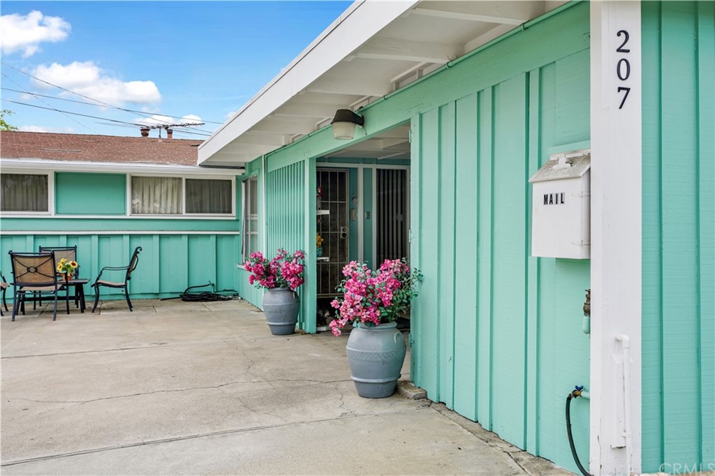 207 Hanover Drive Costa Mesa, CA 92626 - Photo 2 of 7 a view of a chairs and table in front of a house