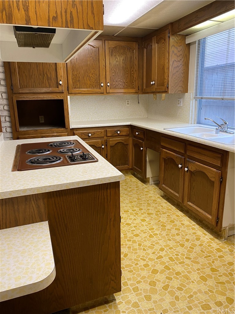 207 Hanover Drive Costa Mesa, CA 92626 - Photo 4 of 7 a kitchen with a sink a stove and cabinets
