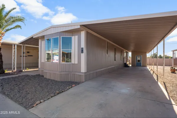 a view of a house with backyard and parking