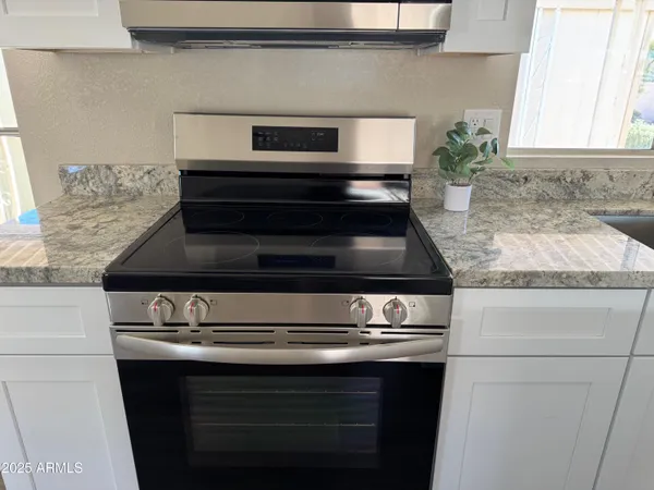 a stove top oven sitting inside of a kitchen