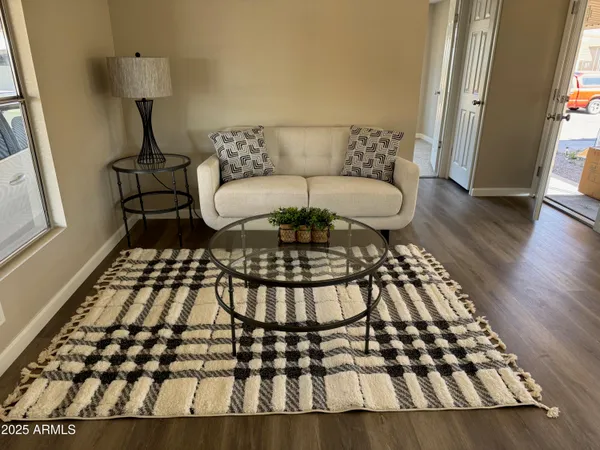 a living room with a rug and a rug