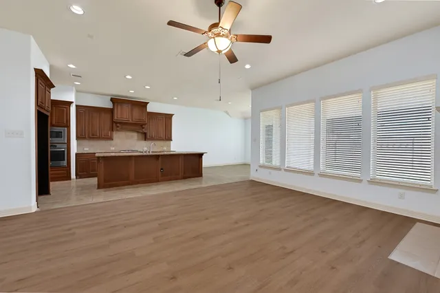 a view of kitchen with granite countertop cabinets and wooden floor
