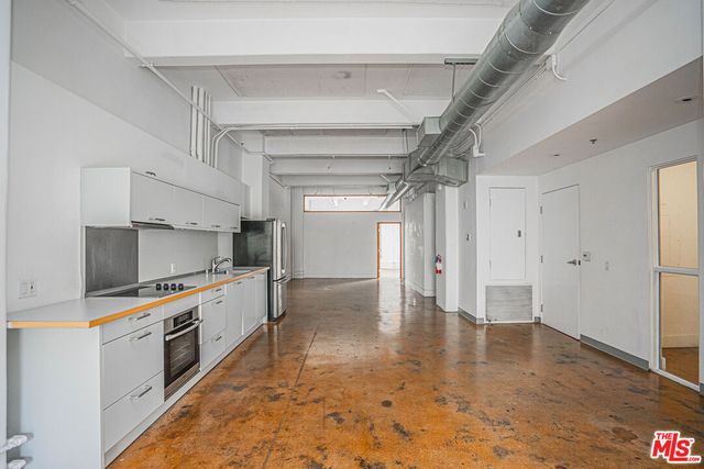 a kitchen with granite countertop a refrigerator and a stove