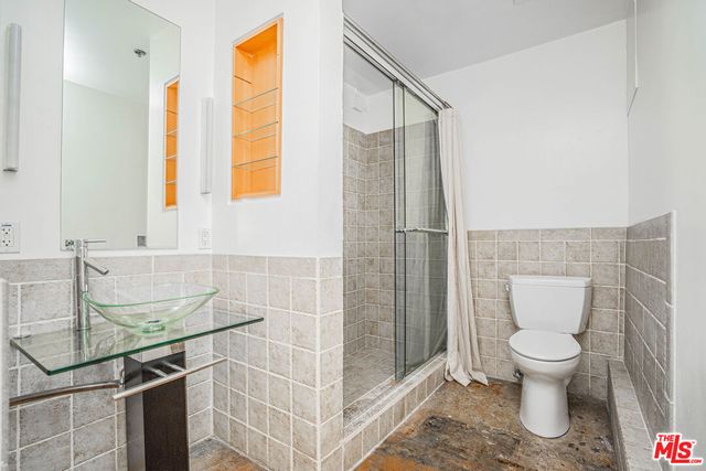 a bathroom with a toilet and a shower