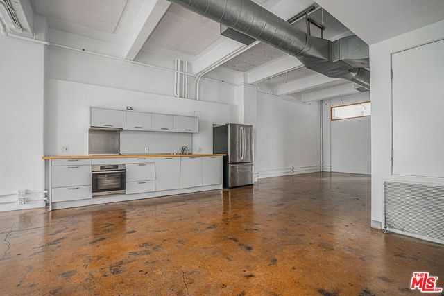 a view of a kitchen with a sink and a stove top oven