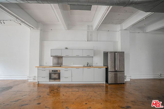 a kitchen with cabinets and stainless steel appliances