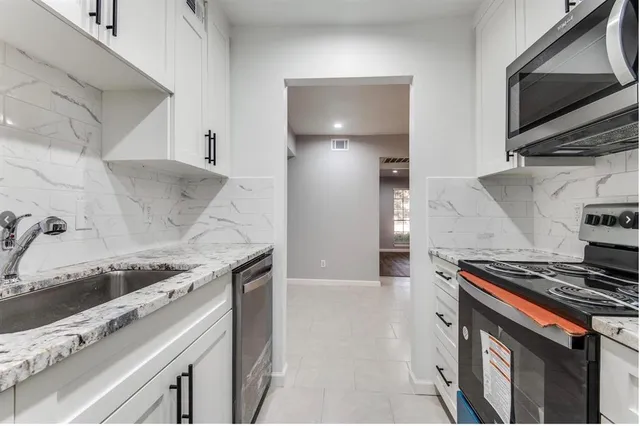 a kitchen with a stove and a microwave