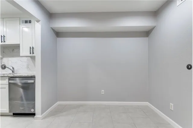 a view of a kitchen with a sink and dishwasher