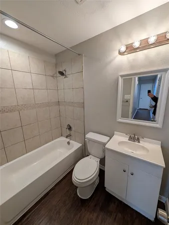 a bathroom with a toilet a sink and bathtub