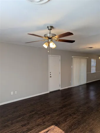 a view of a chandelier fan and wooden floor