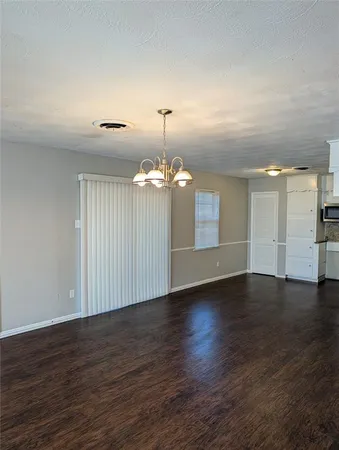 a view of a room with wooden floor and window