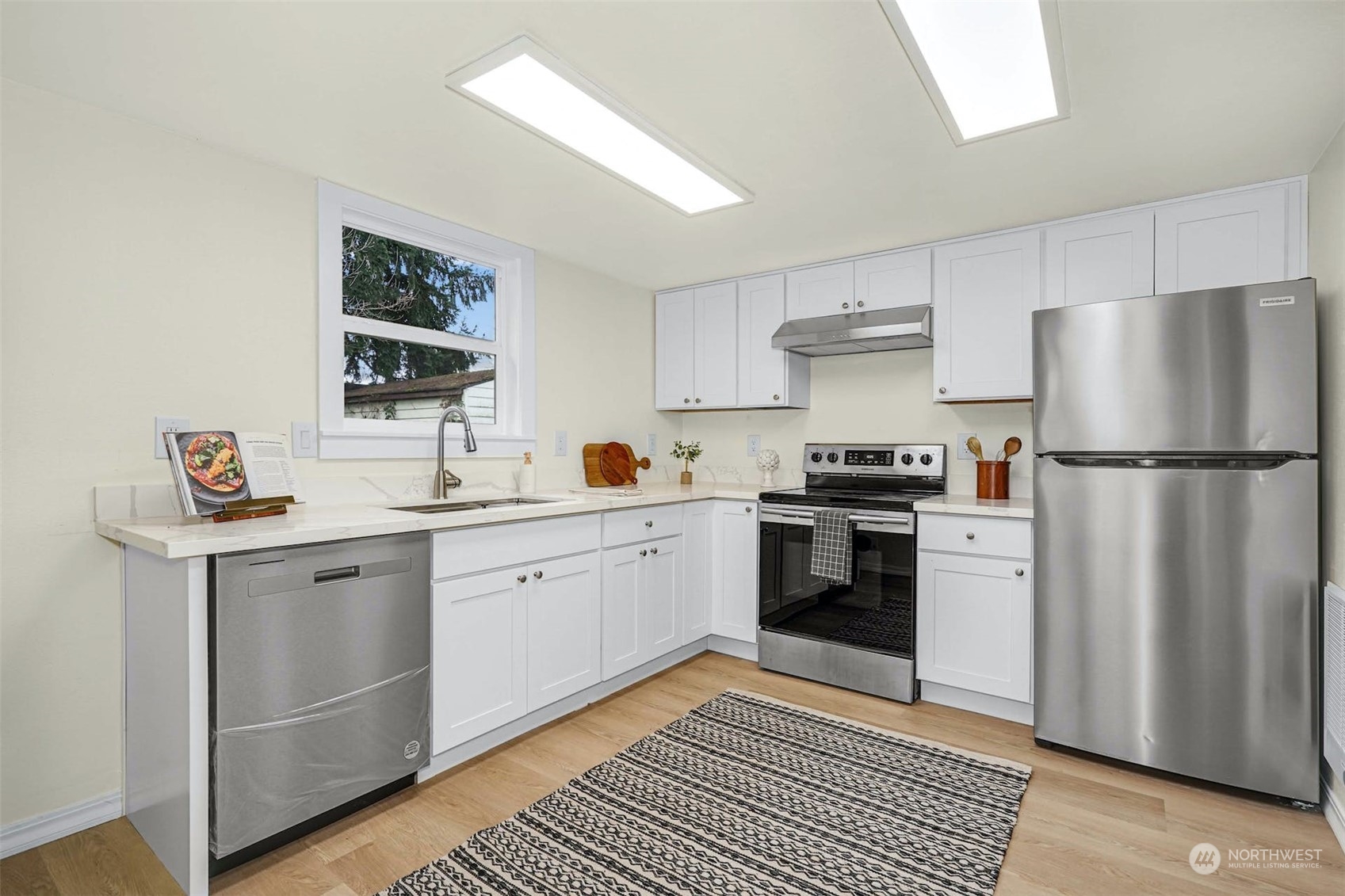 2223 Northeast 8th Place Renton, WA 98056 - Photo 10 of 32 a kitchen with a white stove top oven and refrigerator