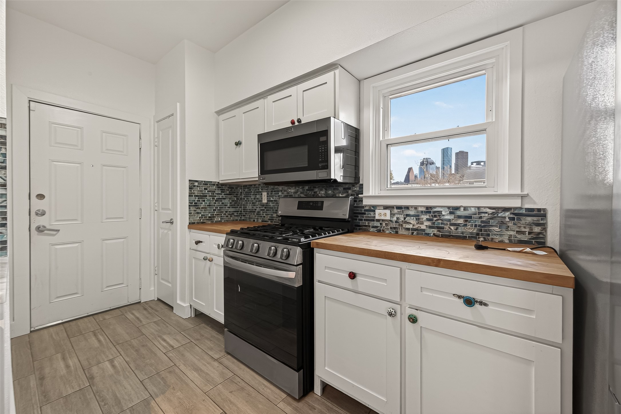 1620 Andrews Street Houston, TX 77019 - Photo 6 of 12 a kitchen with granite countertop cabinets stainless steel appliances and a wooden floor