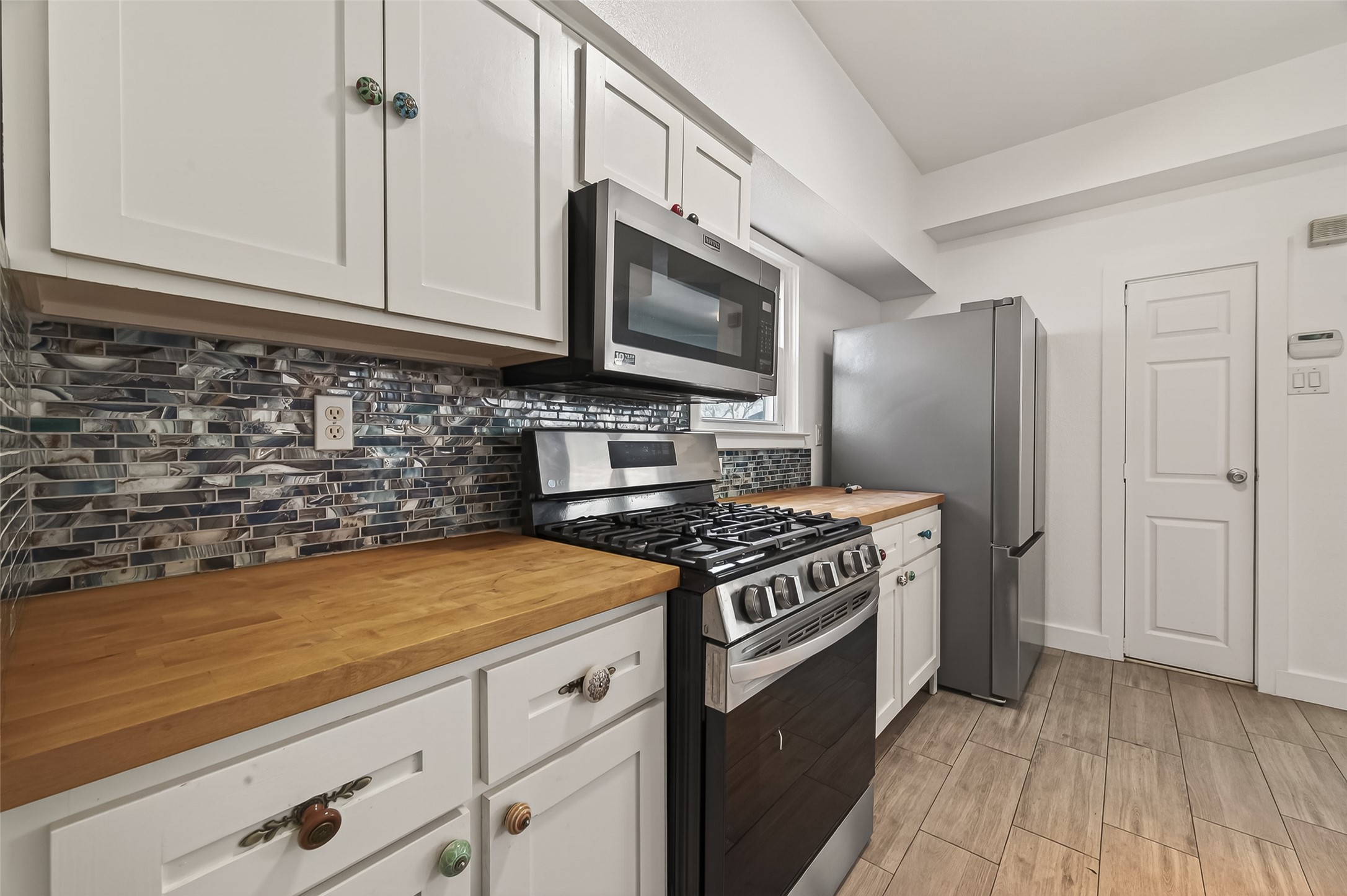 1620 Andrews Street Houston, TX 77019 - Photo 7 of 12 a kitchen with stainless steel appliances granite countertop a stove and a microwave