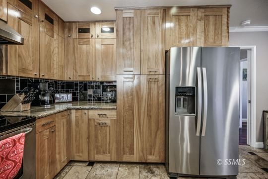 725 West Howell Avenue Ridgecrest, CA 93555 - Photo 17 of 35 a kitchen with stainless steel appliances granite countertop a refrigerator and a sink