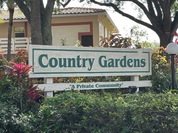 a sign broad in front of flowers
