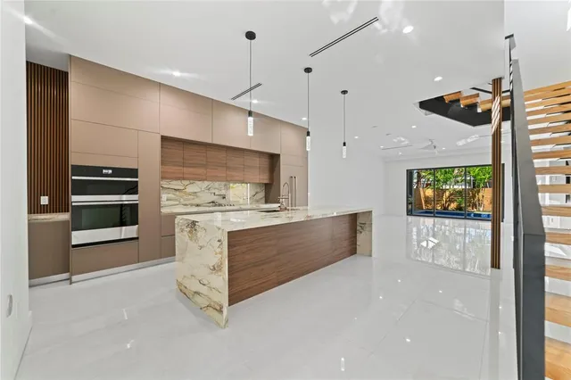 a view of kitchen with refrigerator stove and oven