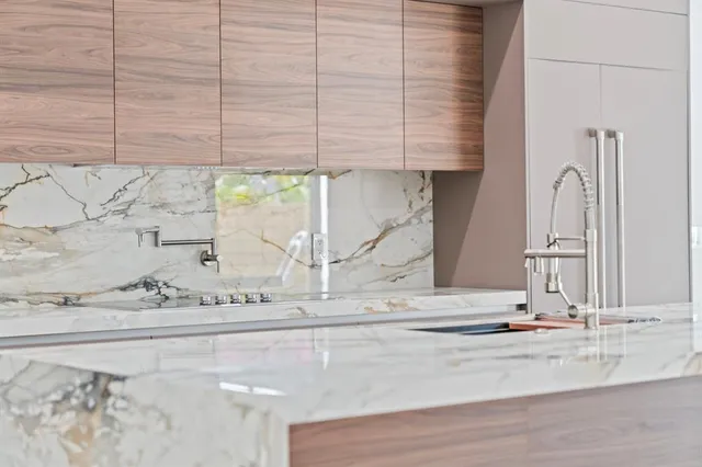a view of a kitchen with kitchen island and windows