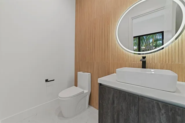 a hallway with white cabinets and couches