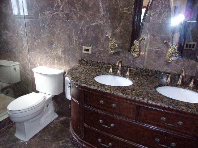 1564 Sunset Way Weston, FL 33327 - Photo 12 of 40 a bathroom with a granite countertop toilet and a sink
