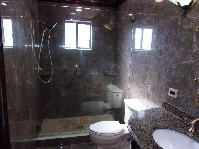 1564 Sunset Way Weston, FL 33327 - Photo 13 of 40 a bathroom with a granite countertop toilet a sink and shower