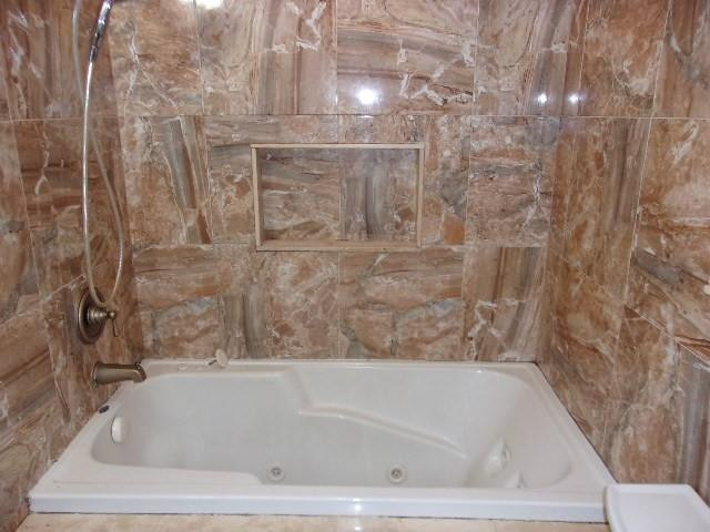 1564 Sunset Way Weston, FL 33327 - Photo 16 of 40 a bathroom with a bathtub