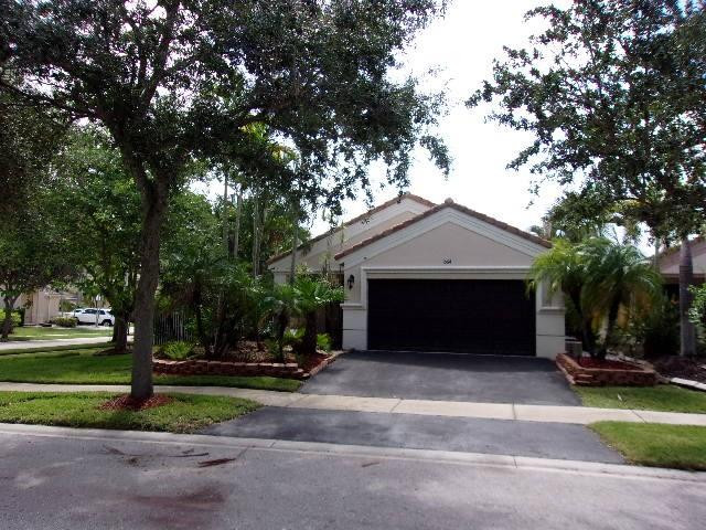 1564 Sunset Way Weston, FL 33327 - Photo 36 of 40 a front view of a house with a yard