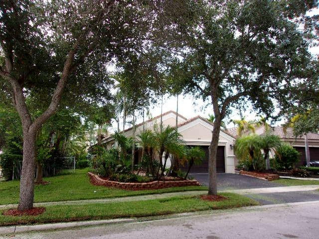 1564 Sunset Way Weston, FL 33327 - Photo 38 of 40 a front view of a house with a yard and tree s