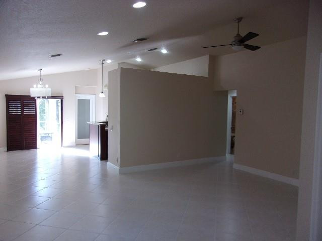 1564 Sunset Way Weston, FL 33327 - Photo 6 of 40 a view of a hallway with wooden floor and a kitchen